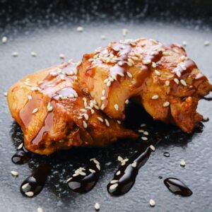 Fried chicken meat with teriyaki sauce, closeup view