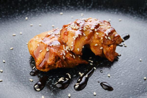 Fried chicken meat with teriyaki sauce, closeup view