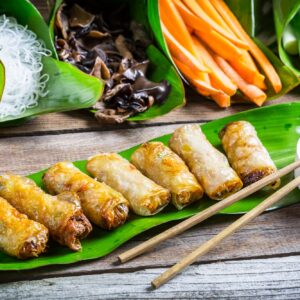 Fried spring rolls surrounded by ingredients