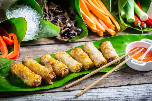 Fried spring rolls surrounded by ingredients