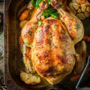 Grilled chicken with thyme and garlic. Roasted chicken with herbs.