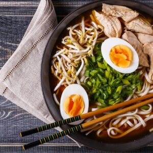 Japanese ramen soup with chicken, egg, chives and sprout.