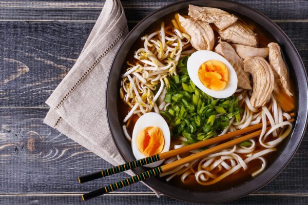 Japanese ramen soup with chicken, egg, chives and sprout.