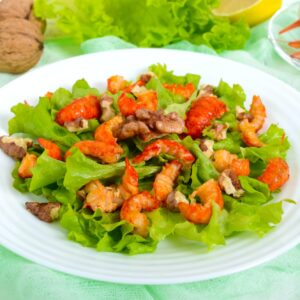 Light dietary spicy salad of lettuce, seafood (crawfish, shrimp) and walnuts