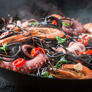 Tasty seafood black pasta with shrimp. Classic Italian dinner.