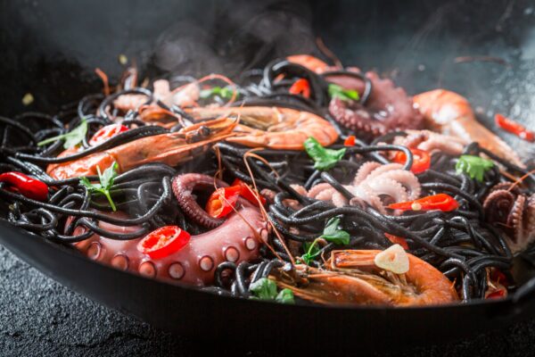 Tasty seafood black pasta with shrimp. Classic Italian dinner.